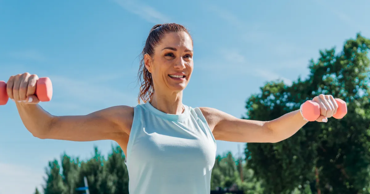 Femme souriante entrain du faire du sport en plein air